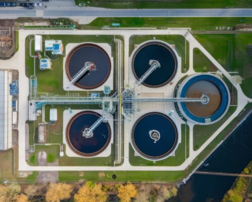 sewage-water-treatment-plant-with-river-foreground-aerial-view